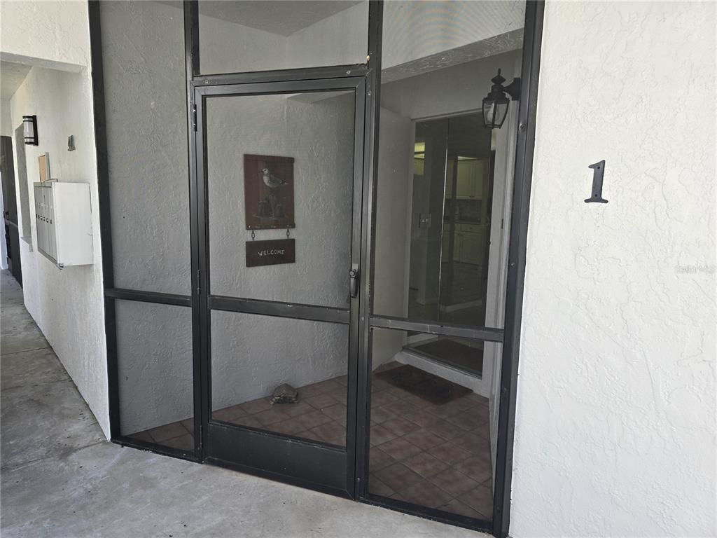 411 South Bayshore Boulevard, Unit 1 Safety Harbor, FL 34695 - Photo 5 of 30 a bathroom with a glass shower door