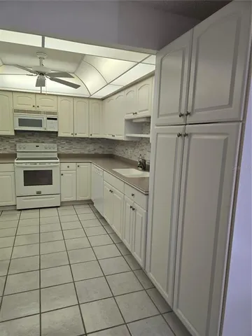 a kitchen with stainless steel appliances a sink and cabinets