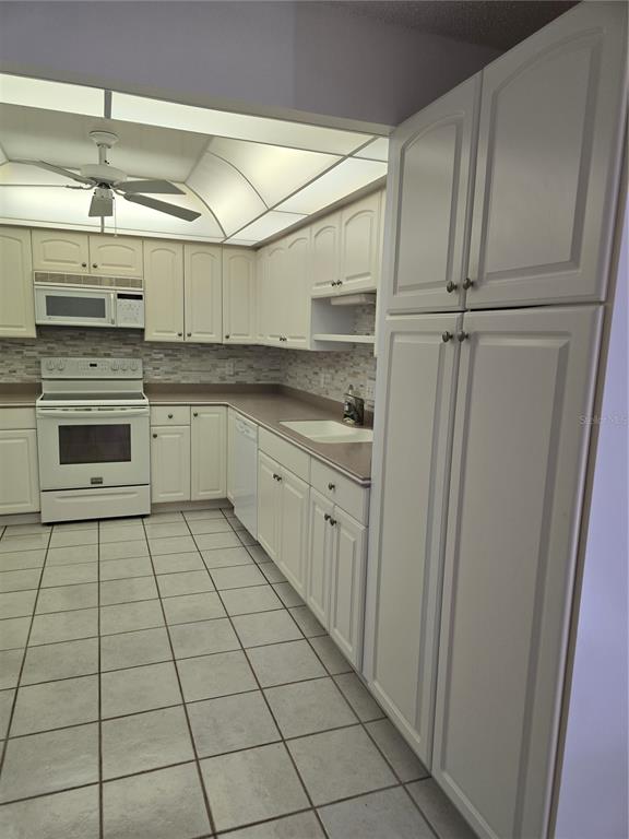 411 South Bayshore Boulevard, Unit 1 Safety Harbor, FL 34695 - Photo 9 of 30 a kitchen with stainless steel appliances a sink and cabinets
