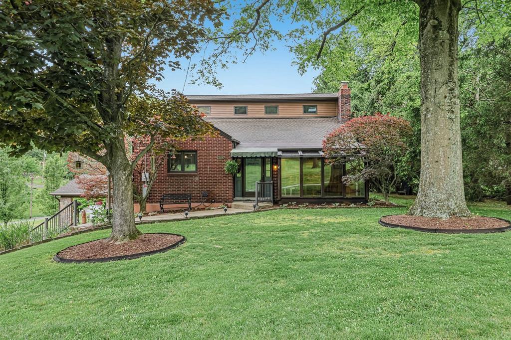 a front view of a house with a garden