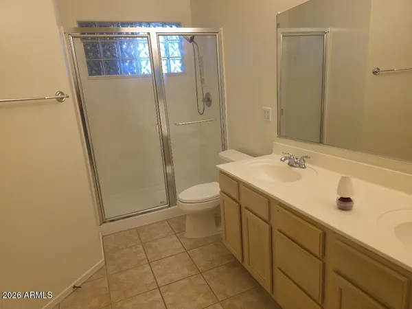 a spacious bathroom with a sink a toilet and shower