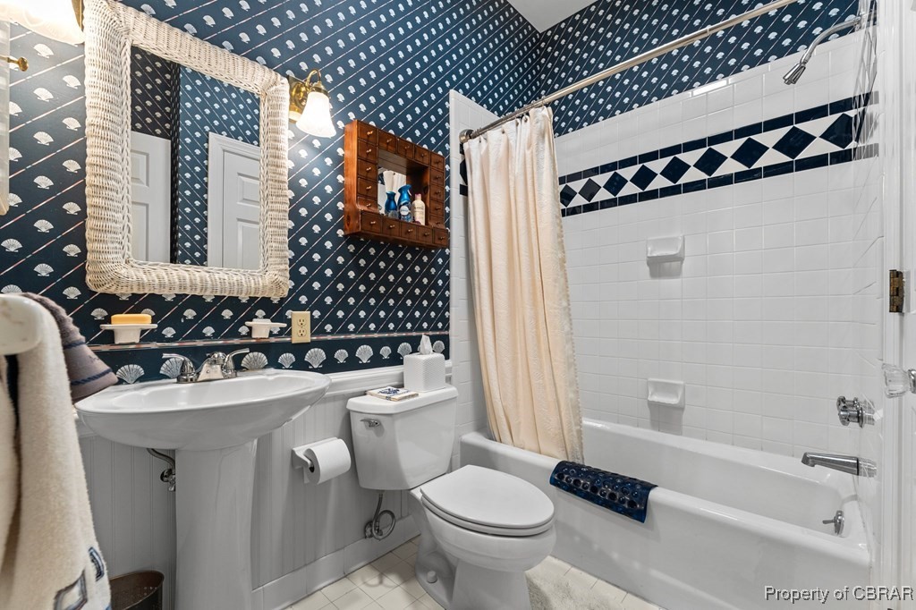 184 York Road Irvington, VA 22480 - Photo 26 of 46 Bathroom with tile patterned floors, toilet, and shower / bath combo with shower curtain