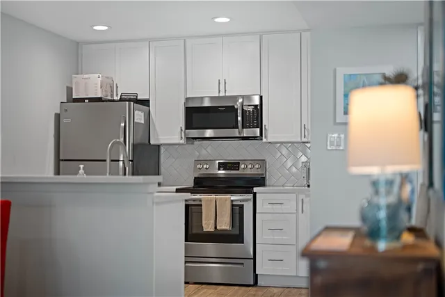 a bedroom with a bed and paintings on wall