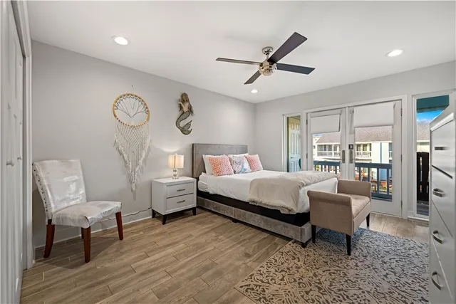 a bed room with a bed and a ceiling fan