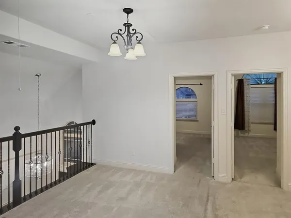 a view of a hallway with a chandelier