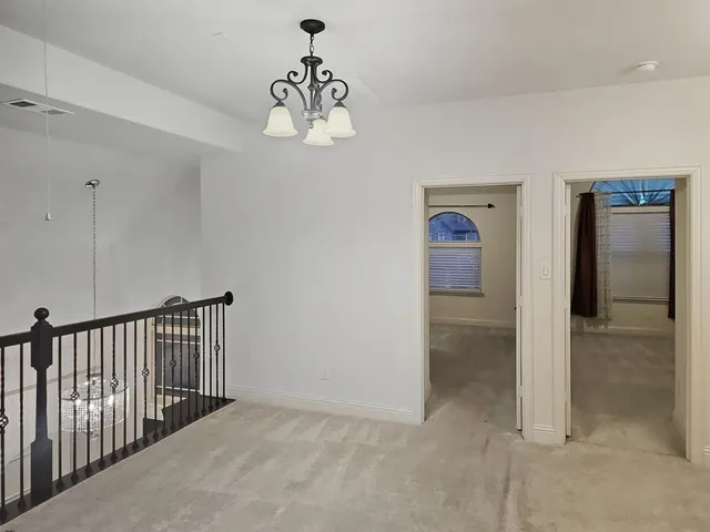 a view of a hallway with a chandelier