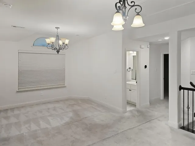 a view of a chandelier fan and entryway