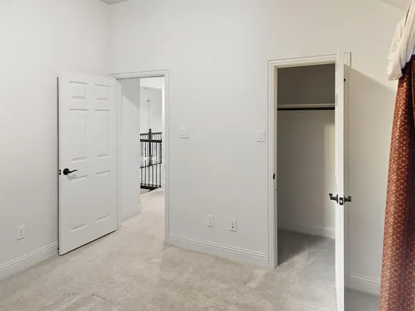 a view of yellow house with wooden fence
