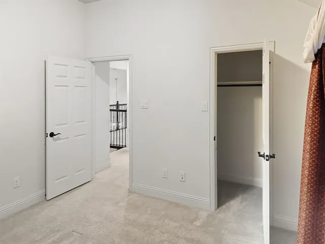 a view of yellow house with wooden fence