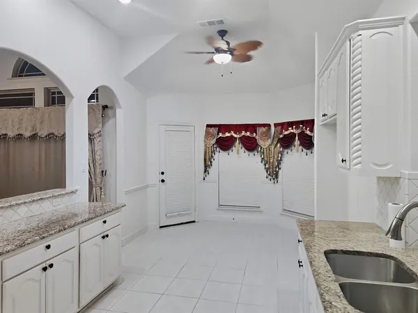 a bathroom with a granite countertop sink mirror and shower