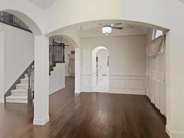 a view of a room with wooden floors and stairs
