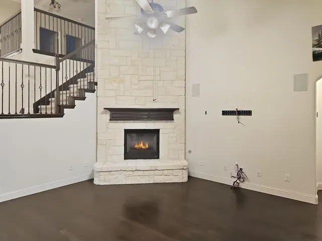 a view of a livingroom with wooden floor and a fireplace