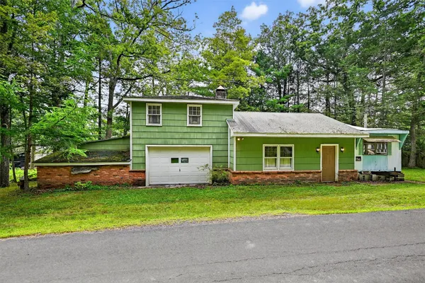 a front view of house with yard and green space