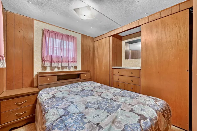 a bedroom with a bed and a dresser