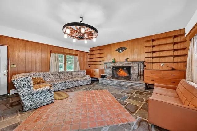 a living room with furniture a fireplace and a table