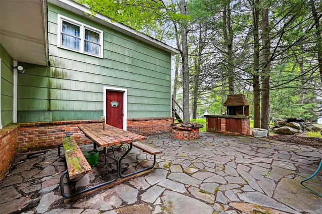 a view of a backyard with chairs and a fire pit