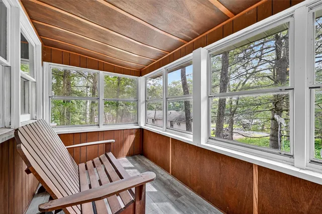a view of a room with wooden floor and furniture