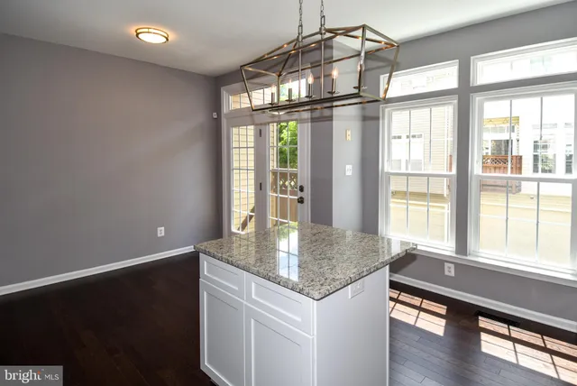 a kitchen with stainless steel appliances granite countertop a sink and a large window