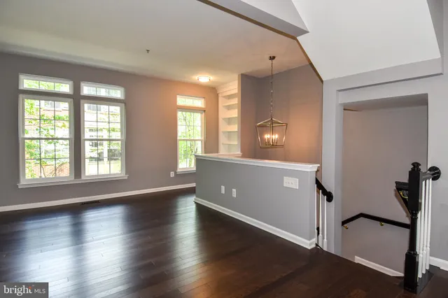a view of a livingroom with wooden floor and a window