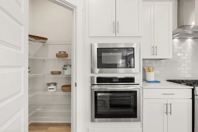 a kitchen with cabinets and appliances