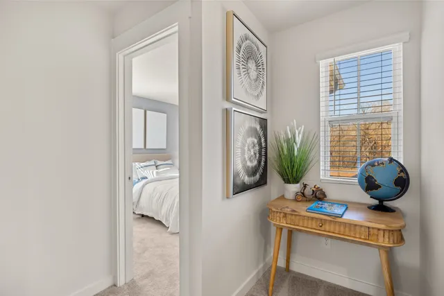 a bed sitting in a bedroom next to a window