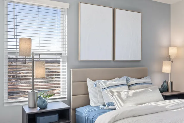 a bedroom with a bed and a night stand