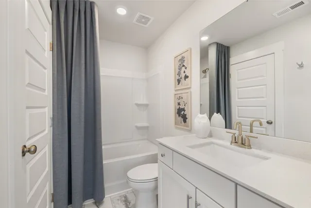 a spacious bedroom with two beds and a large window