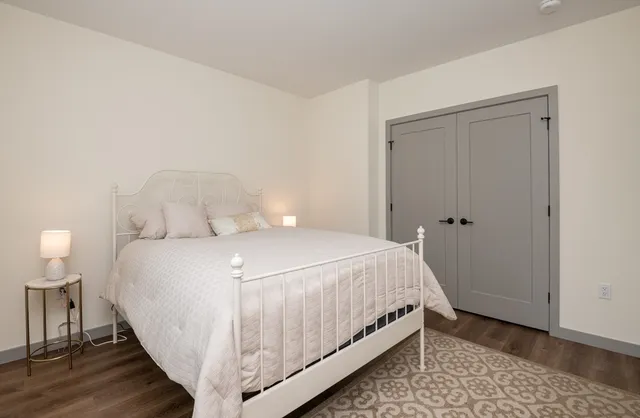 a bedroom with a bed and a table