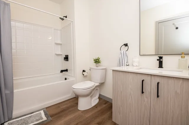 a bathroom with a sink toilet a mirror and shower