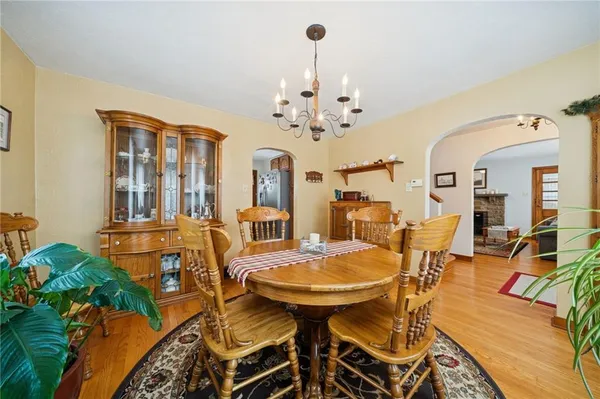 a view of a dining room with furniture and chandelier