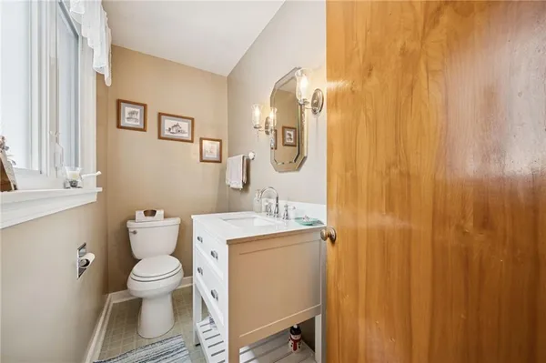 a bathroom with a toilet a sink and a mirror