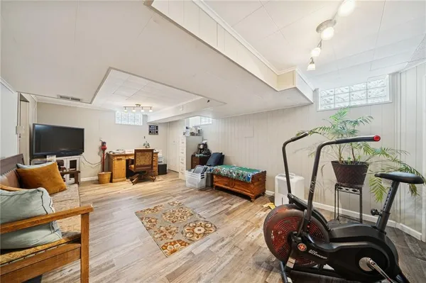 a living room with furniture a flat screen tv and a table