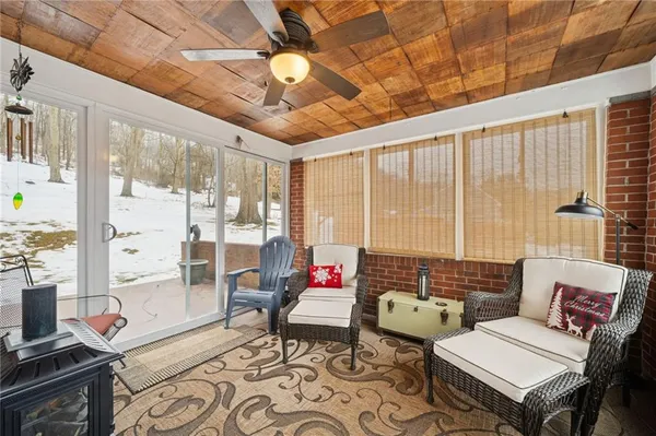 a living room with furniture and a floor to ceiling window