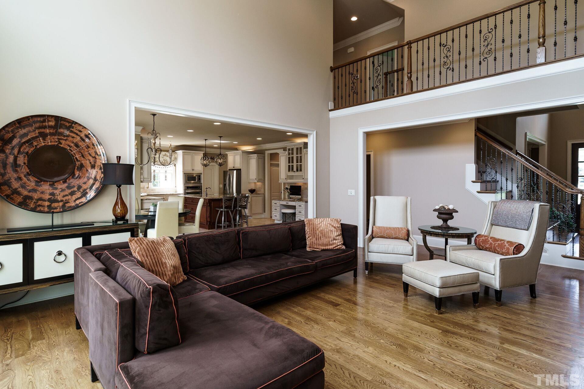 8313 Rue Cassini Court Raleigh, NC 27615 - Photo 12 of 74 a living room with furniture and a wooden floor