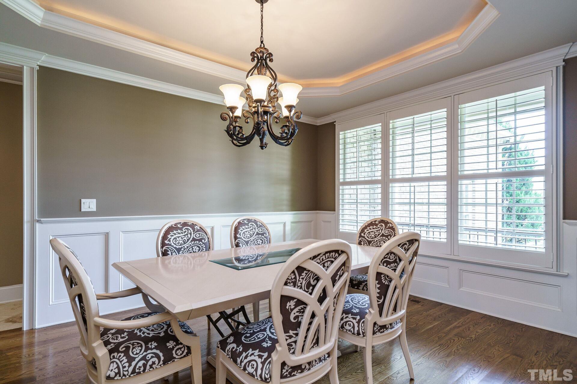 8313 Rue Cassini Court Raleigh, NC 27615 - Photo 17 of 74 a view of a dining room with furniture window and wooden floor