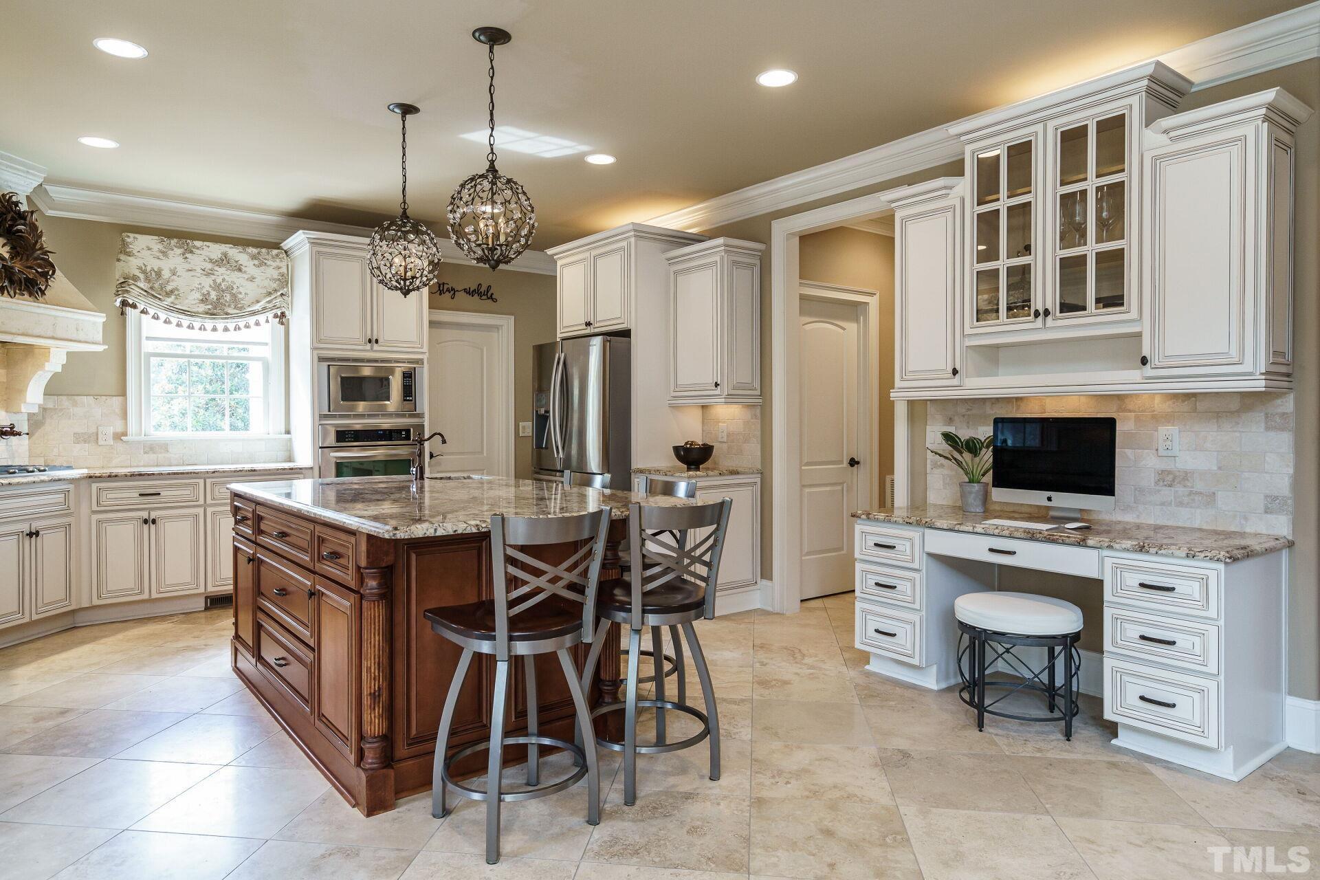 8313 Rue Cassini Court Raleigh, NC 27615 - Photo 20 of 74 a kitchen with stainless steel appliances granite countertop a stove and a refrigerator