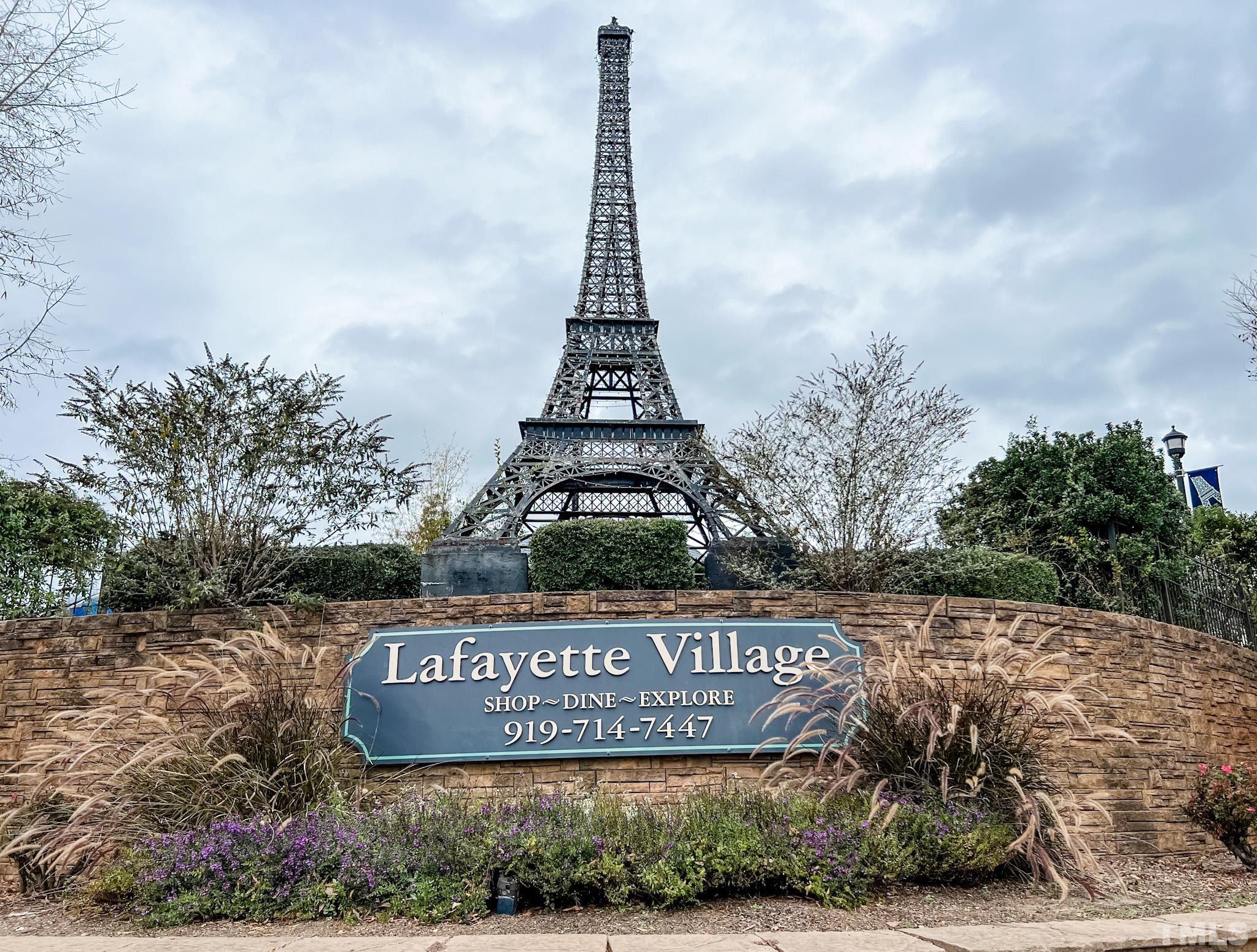 8313 Rue Cassini Court Raleigh, NC 27615 - Photo 2 of 74 a view of outdoor space with signage and flags