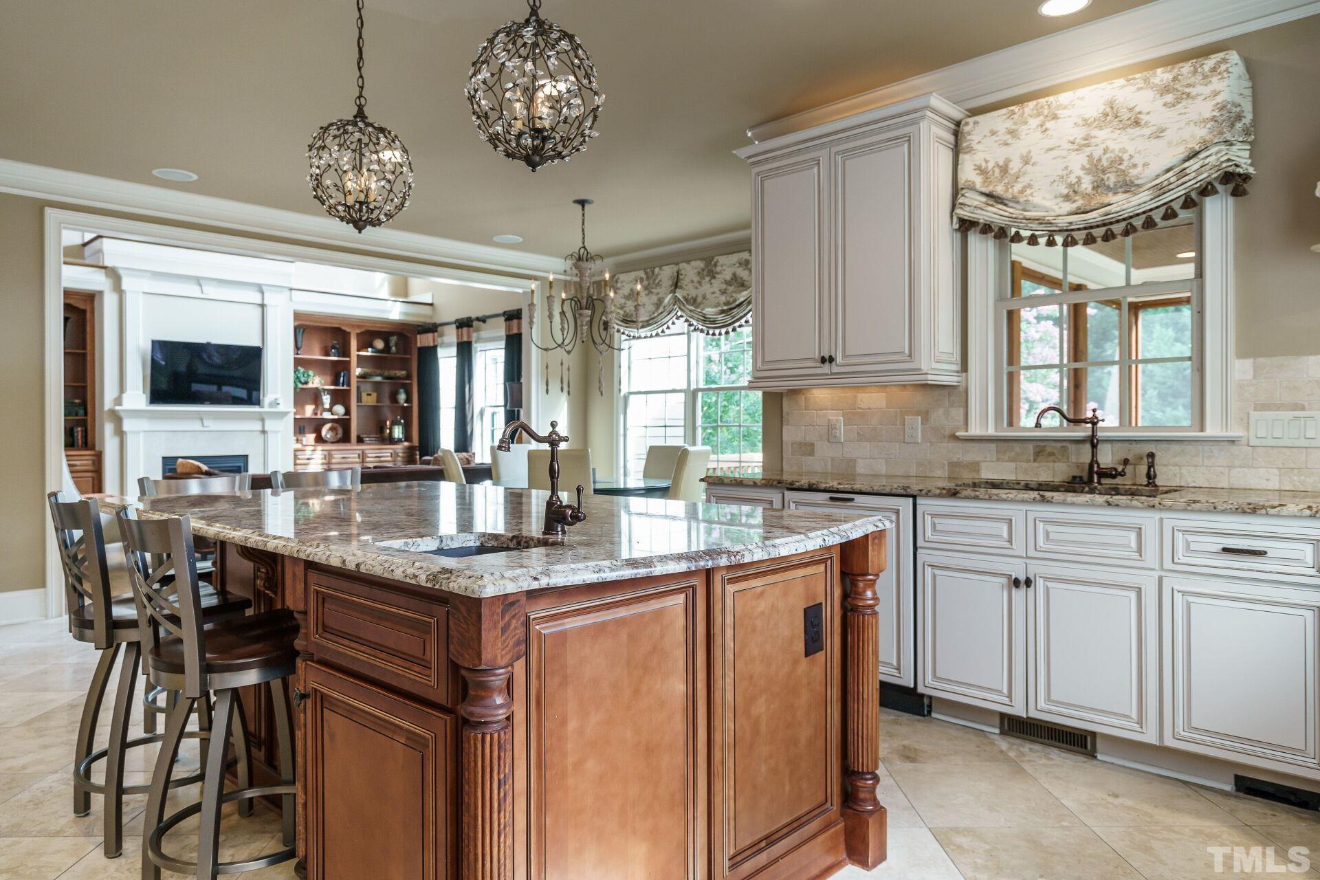 8313 Rue Cassini Court Raleigh, NC 27615 - Photo 21 of 74 a kitchen with a counter space a sink and cabinets