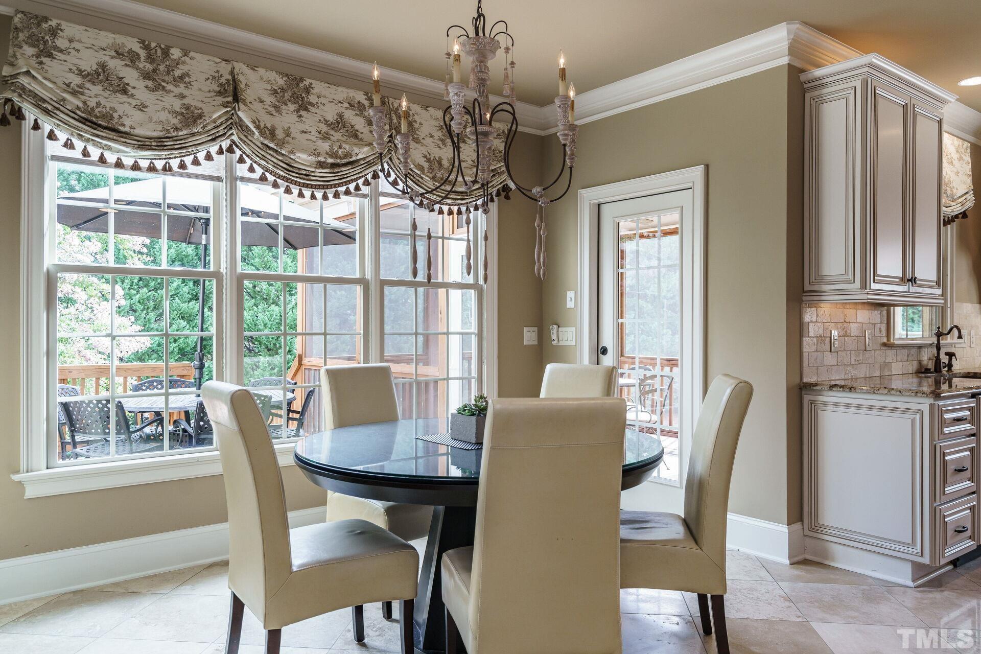 8313 Rue Cassini Court Raleigh, NC 27615 - Photo 22 of 74 a view of a dining room with furniture window and outside view