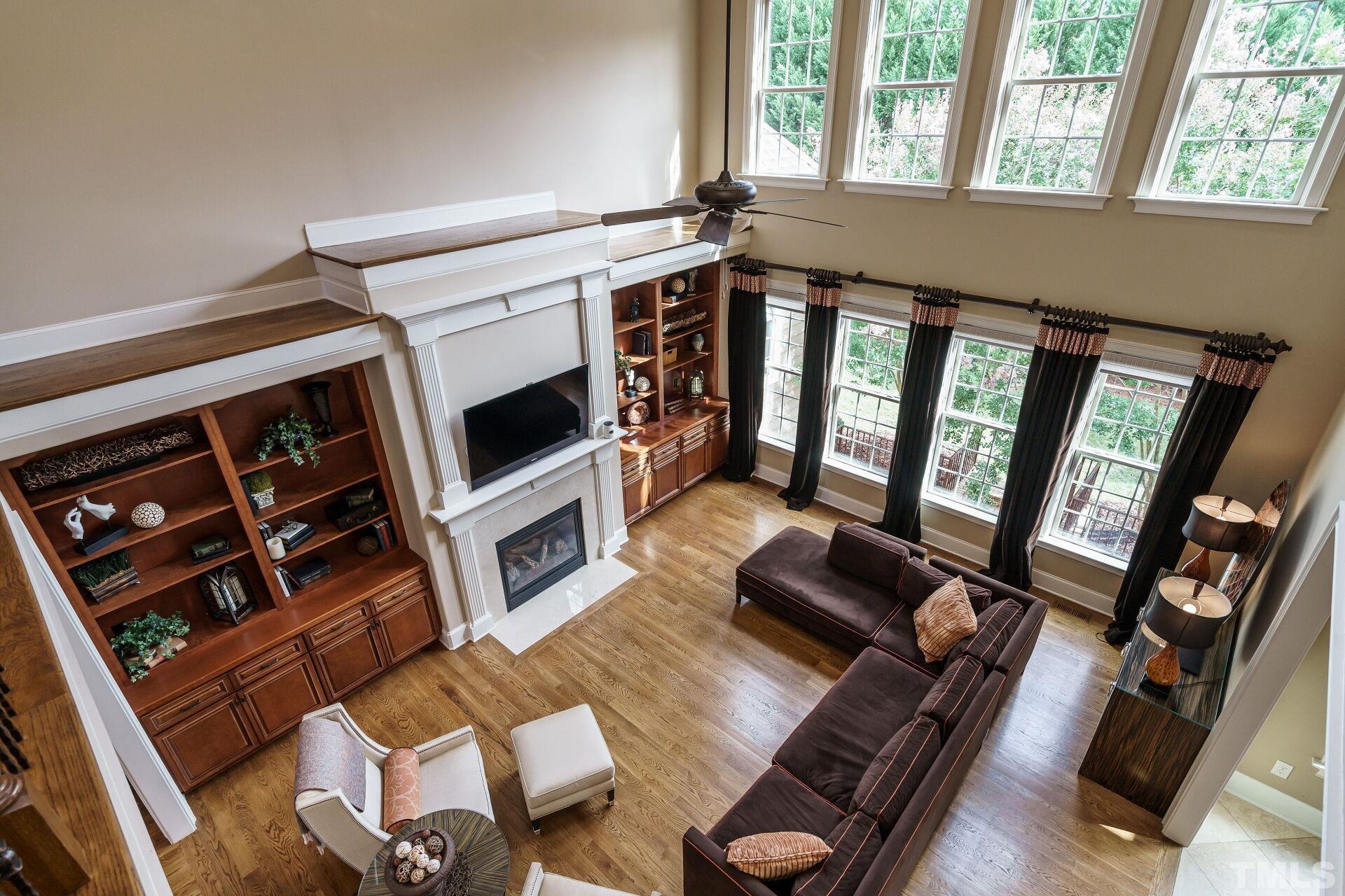 8313 Rue Cassini Court Raleigh, NC 27615 - Photo 28 of 74 a living room with furniture fireplace and flat screen tv