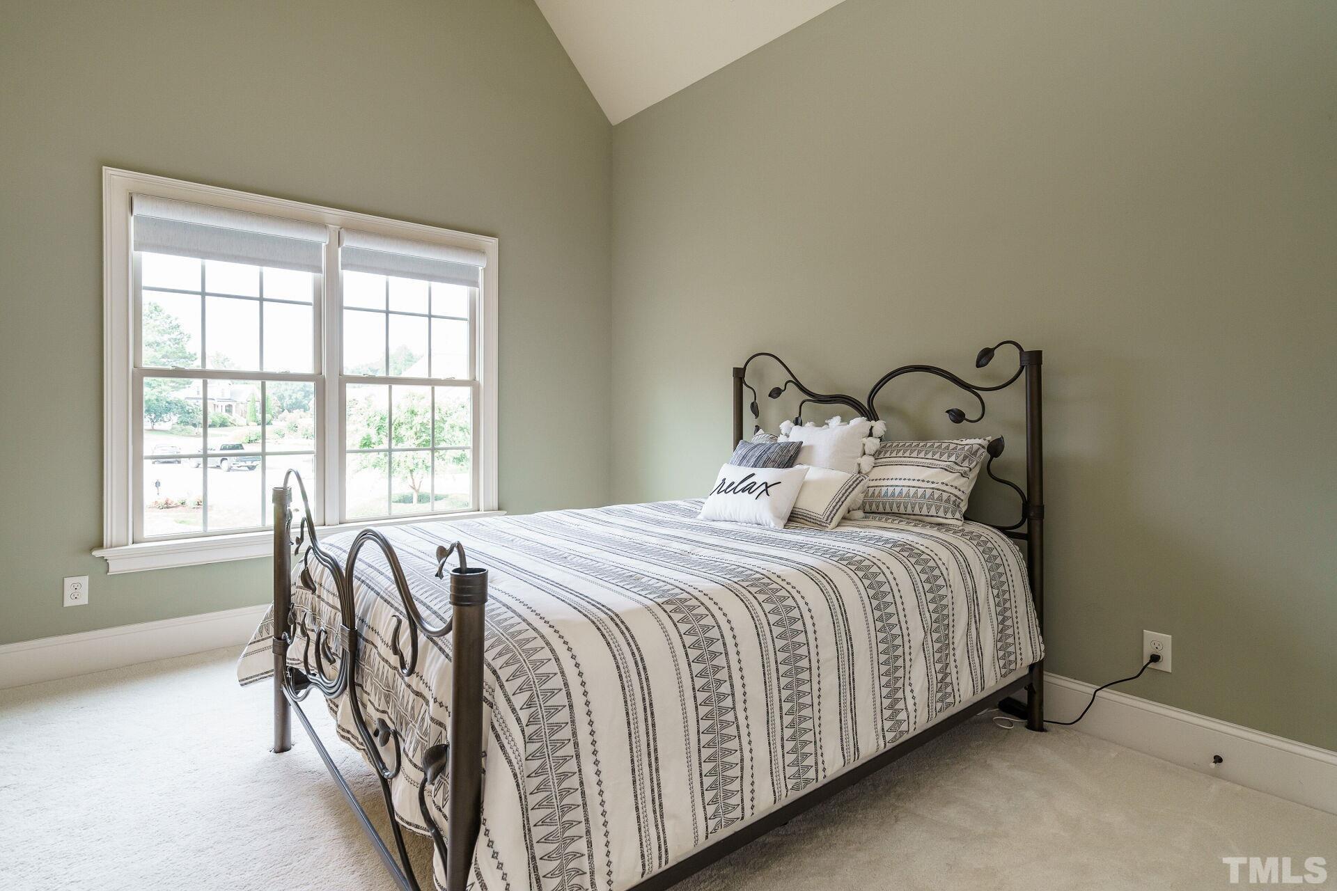 8313 Rue Cassini Court Raleigh, NC 27615 - Photo 33 of 74 a bedroom with a bed and a window