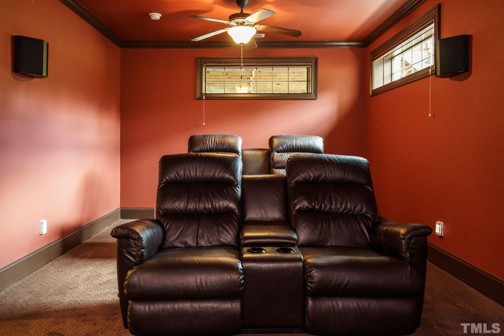 8313 Rue Cassini Court Raleigh, NC 27615 - Photo 48 of 74 a projector room with a couch and a fan