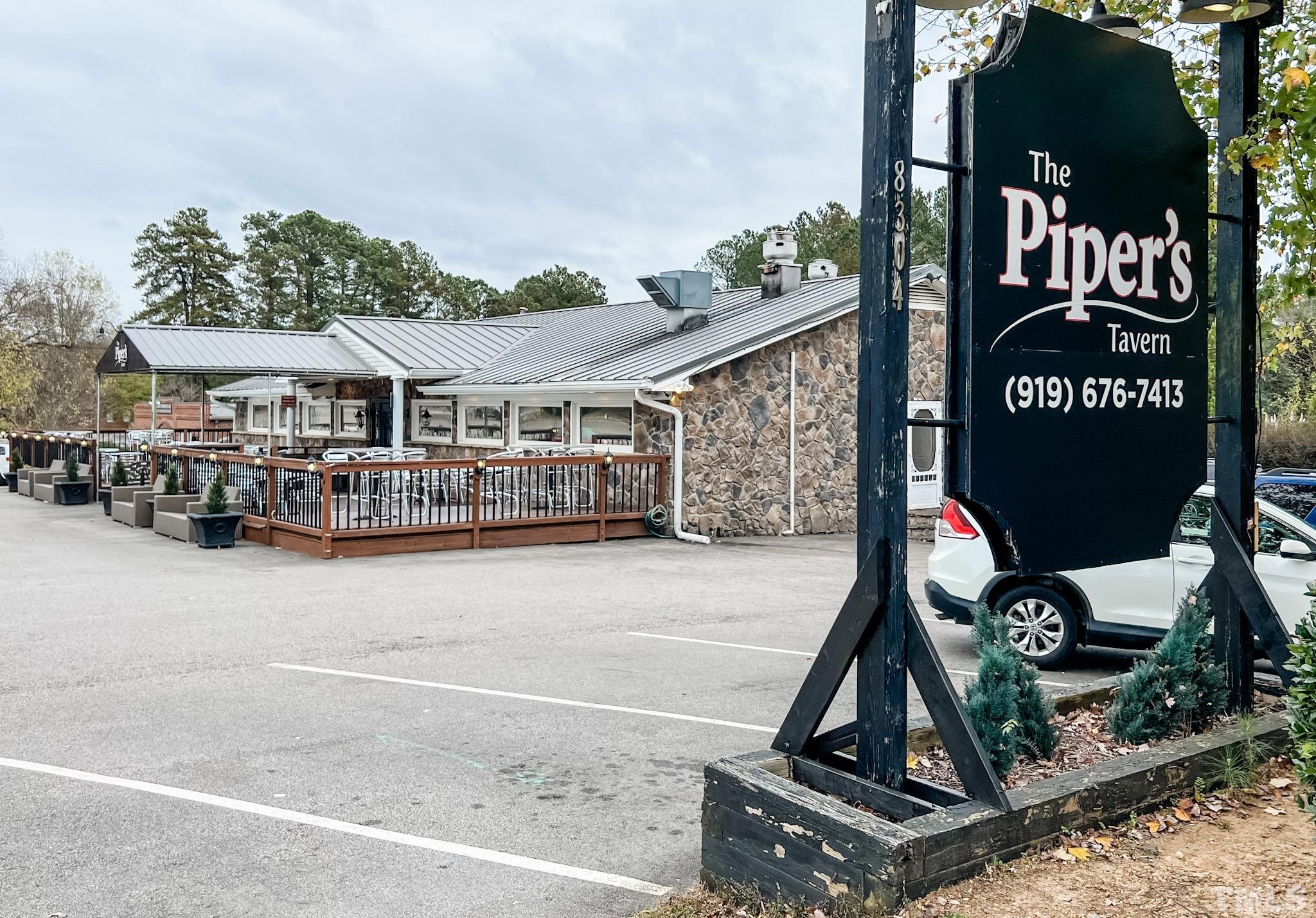 8313 Rue Cassini Court Raleigh, NC 27615 - Photo 5 of 74 a view of a building with a wooden fence