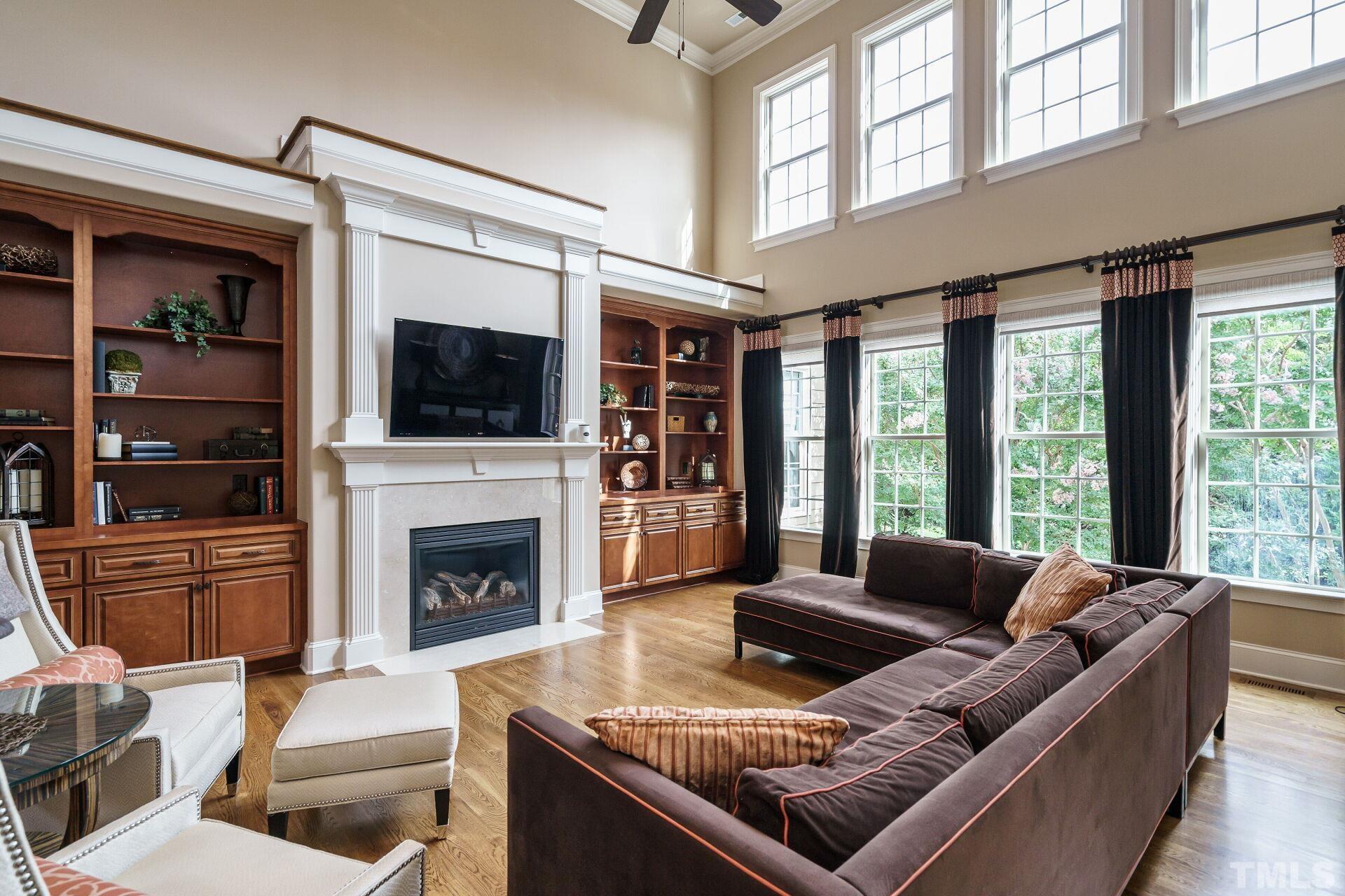 8313 Rue Cassini Court Raleigh, NC 27615 - Photo 10 of 74 a living room with furniture fireplace and flat screen tv
