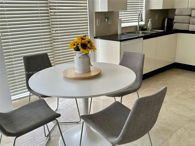 a kitchen with a table and chairs in it