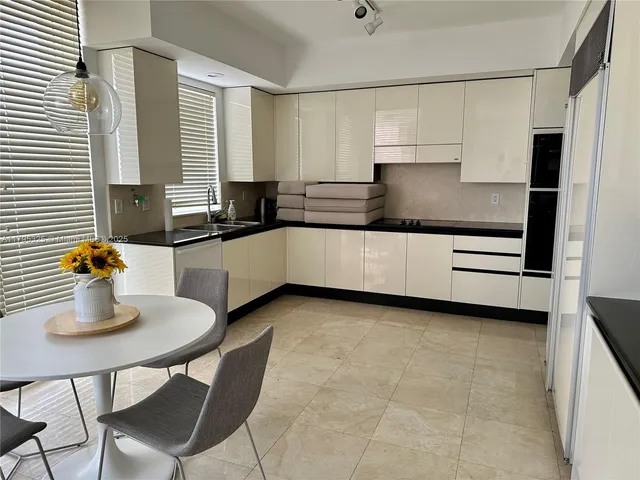 a kitchen with stainless steel appliances granite countertop a sink and cabinets