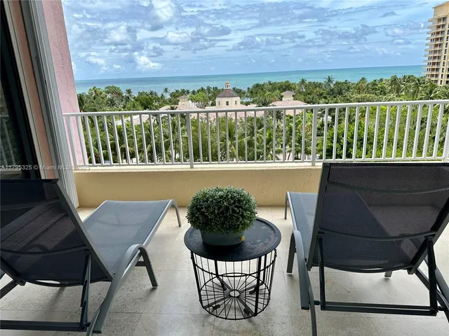 a view of a chairs and table in the balcony