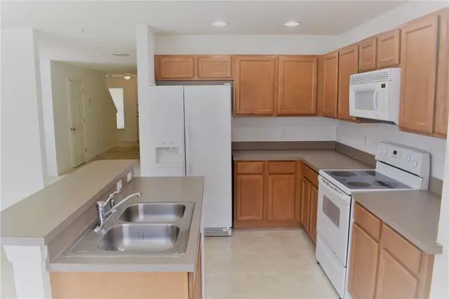 a kitchen with a sink stove and refrigerator
