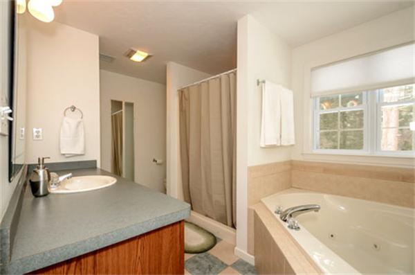 549 Potter Road Framingham, MA 01701 - Photo 15 of 22 a bathroom with a granite countertop sink and a bathtub