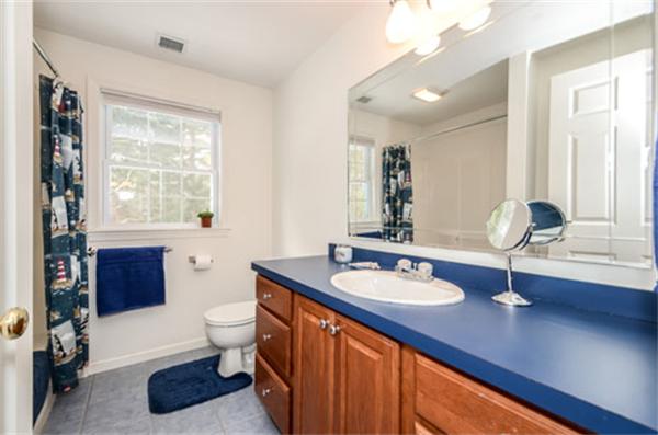 549 Potter Road Framingham, MA 01701 - Photo 19 of 22 a bathroom with a sink double vanity and a large mirror